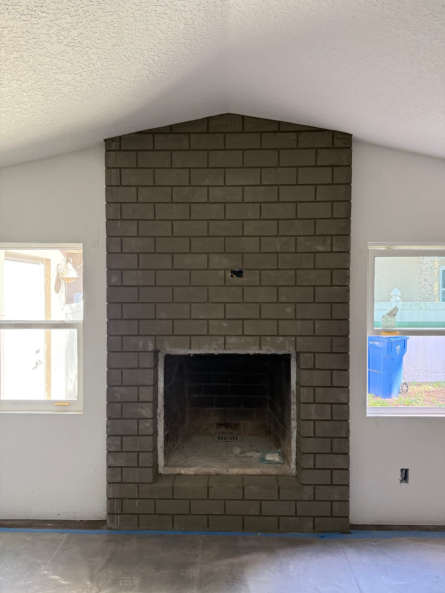 Interior brick fireplace with custom stucco texture finish