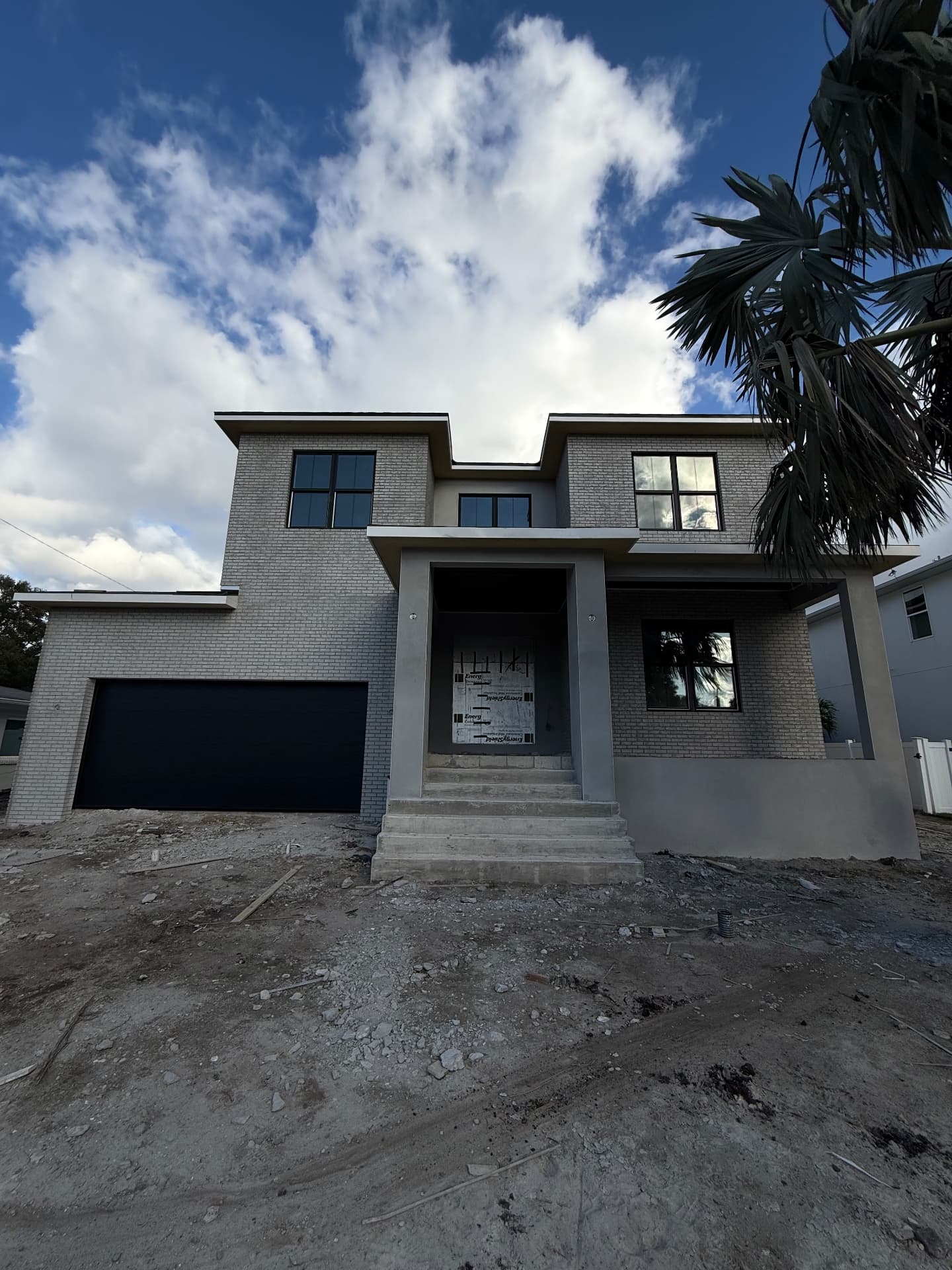Two-story new construction home with brick and stucco exterior